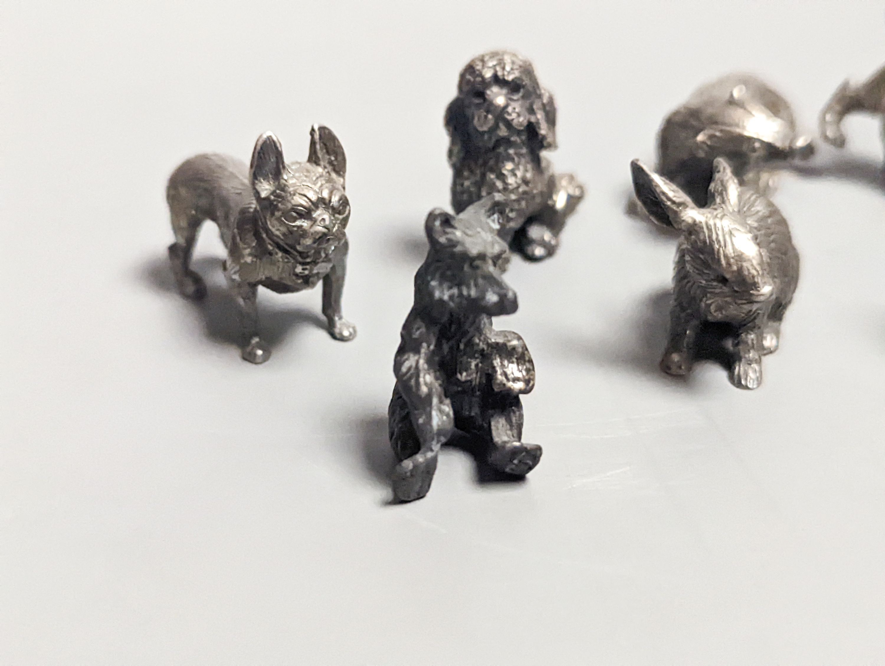 Four modern miniature freestanding model animals, including, badger, two dogs and a cat, JJSM, London, 1989 &1991, cat length 37mm, two Italian 925 models and two base metal models.